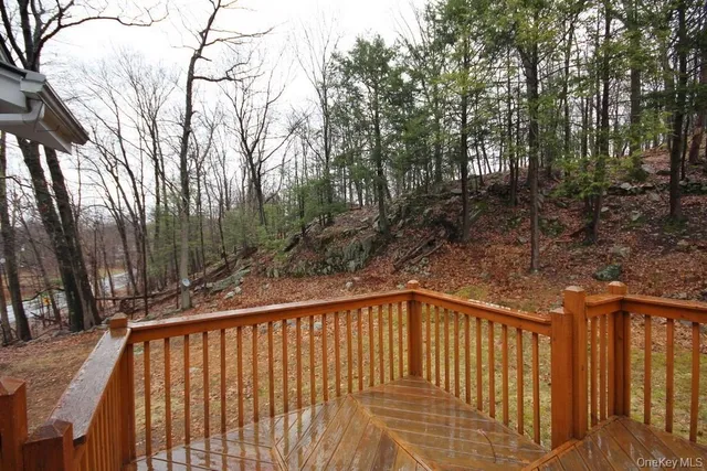 a view of trees and wooden fence