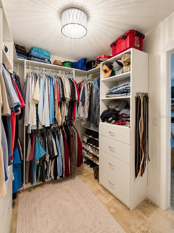 5431 Foley Square New Port Richey, FL 34652 - Photo 22 of 39 a view of walk in closet with clothes