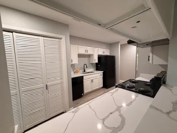 a kitchen with a refrigerator and a sink