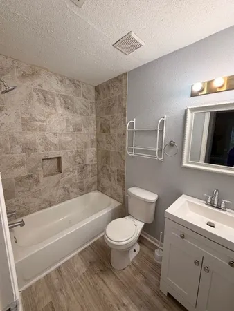 a bathroom with a toilet a sink and bathtub