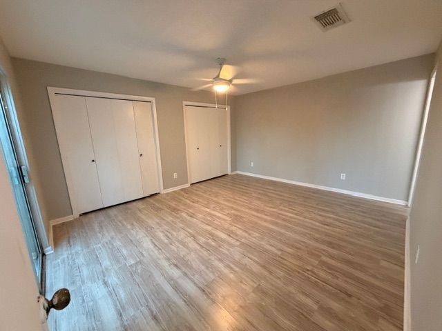 2955 Shadow Trail Drive Houston, TX 77082 - Photo 17 of 19 wooden floor in an empty room with a window