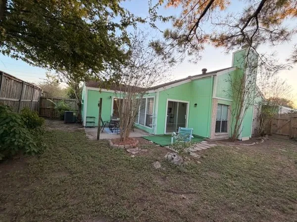 a view of a house with a backyard
