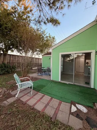 a backyard of a house with table and chairs