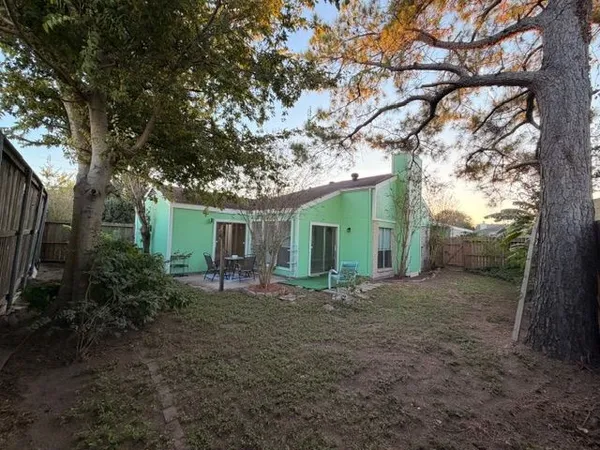 a view of a house with large trees and a barn