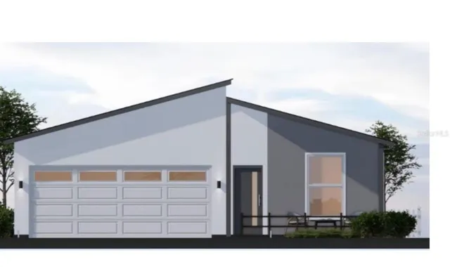 a front view of a house with plants