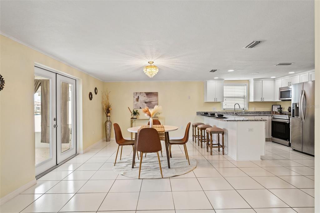 7401 Islander Lane Hudson, FL 34667 - Photo 12 of 30 a kitchen with a dining table chairs and white appliances