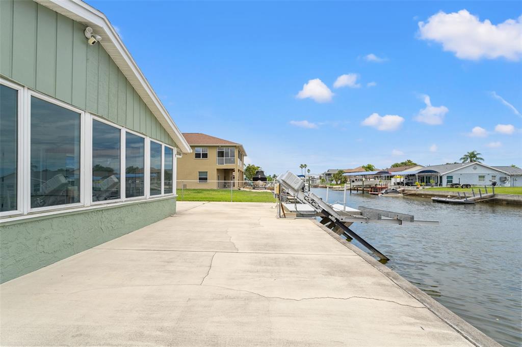 7401 Islander Lane Hudson, FL 34667 - Photo 25 of 30 a view of swimming pool with outdoor seating and lake view