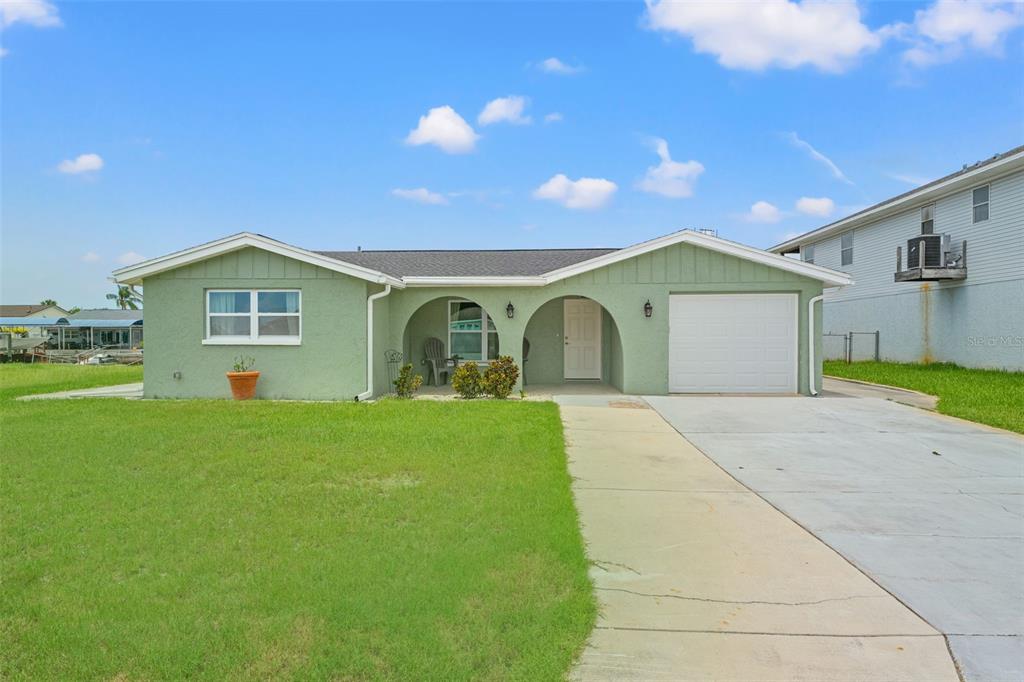 7401 Islander Lane Hudson, FL 34667 - Photo 30 of 30 a view of an house with backyard space and garden