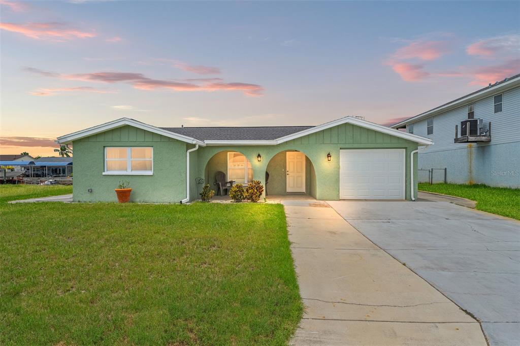 7401 Islander Lane Hudson, FL 34667 - Photo 4 of 30 a view of a house with a garden