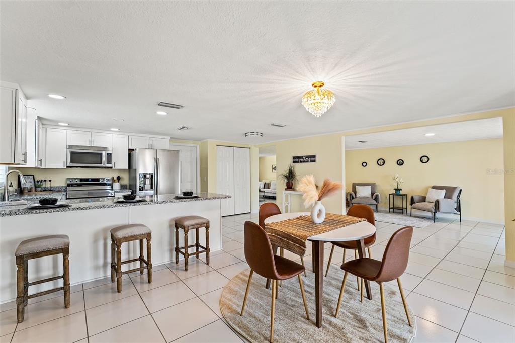 7401 Islander Lane Hudson, FL 34667 - Photo 9 of 30 a dining room with furniture and a chandelier