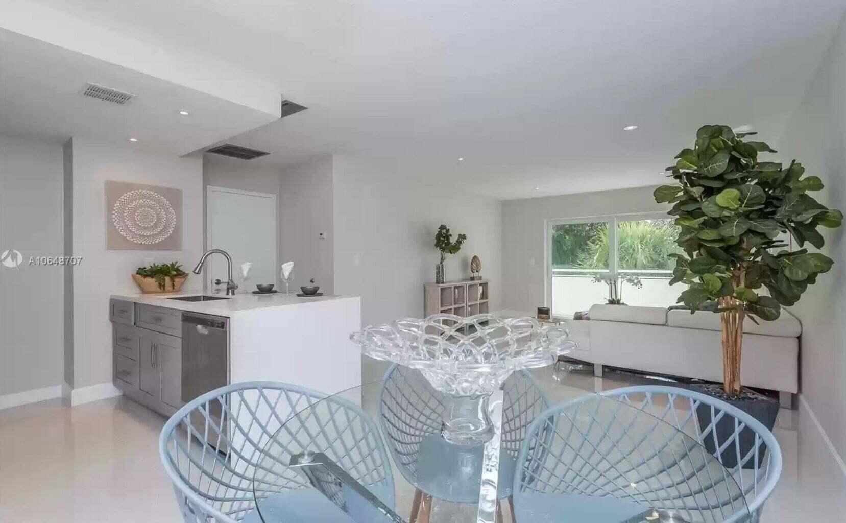3212 Northeast 12th Street, Unit 302 Pompano Beach, FL 33062 - Photo 16 of 25 a living room with furniture and a potted plant