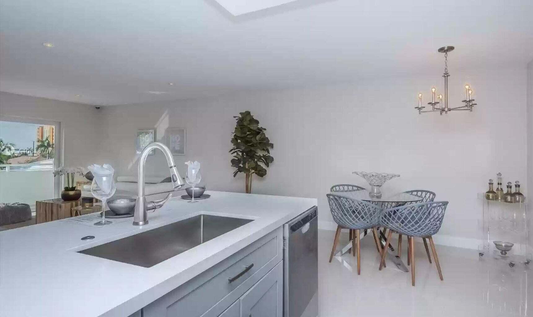 3212 Northeast 12th Street, Unit 302 Pompano Beach, FL 33062 - Photo 17 of 25 a kitchen with a table and chairs in it