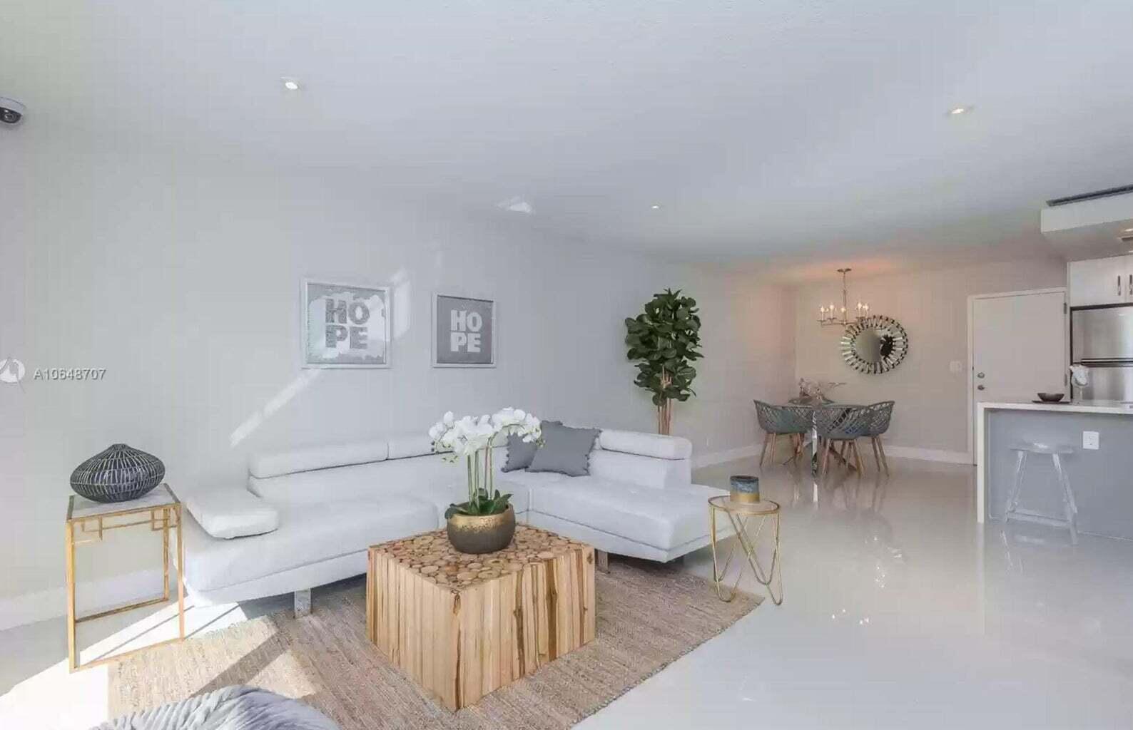 3212 Northeast 12th Street, Unit 302 Pompano Beach, FL 33062 - Photo 18 of 25 a living room with furniture and a potted plant