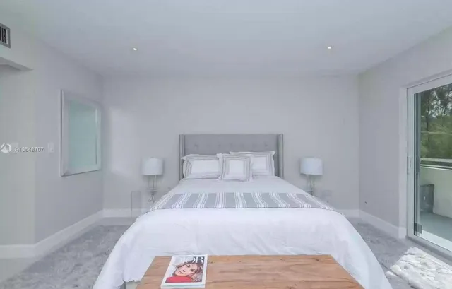 a bed room with a bed and a window