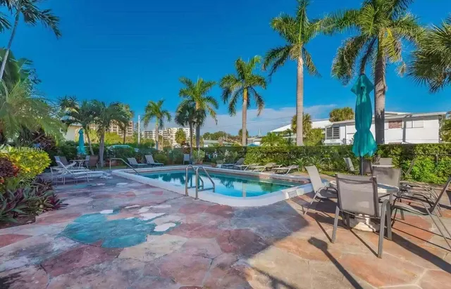 a view of a backyard with a patio table and chairs