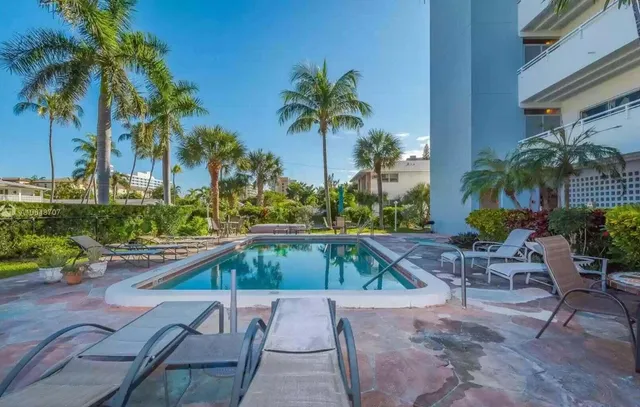 a view of swimming pool with outdoor seating and plants