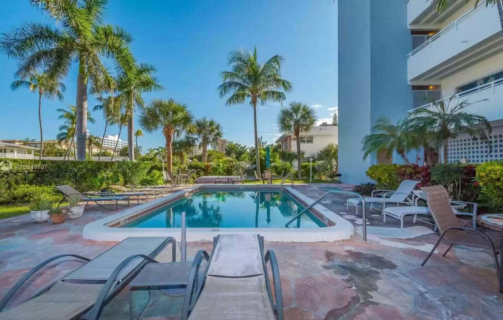 3212 Northeast 12th Street, Unit 302 Pompano Beach, FL 33062 - Photo 6 of 25 a view of swimming pool with outdoor seating and plants