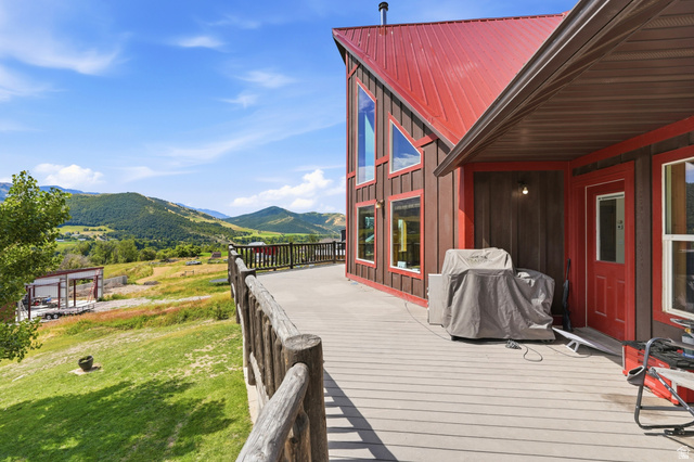 306 Spring Road Preston, ID 83263 - Photo 53 of 55 Expansive exterior deck featuring durable composite decking and a rustic log railing system
