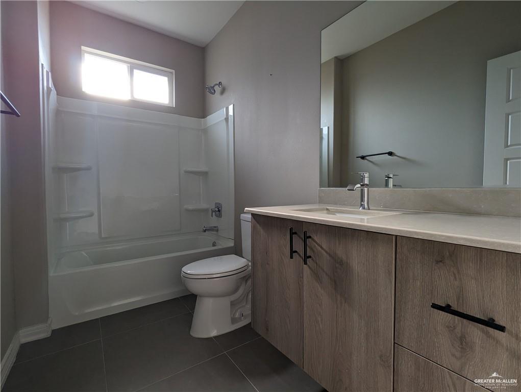 5905 Puffin Avenue, Unit 1 Mission, TX 78573 - Photo 11 of 12 a bathroom with a sink toilet and shower