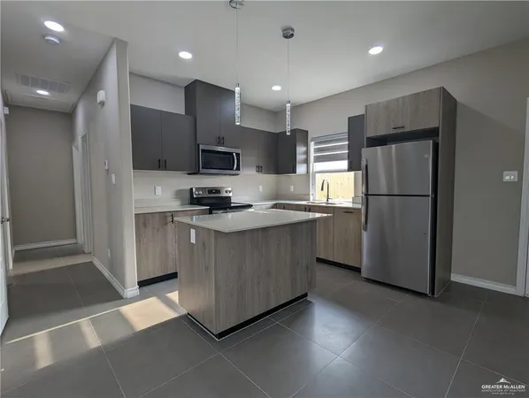 a kitchen with stainless steel appliances granite countertop a refrigerator sink and cabinets