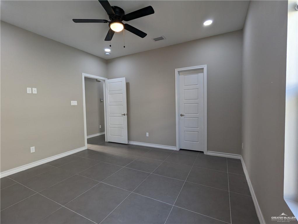 5905 Puffin Avenue, Unit 1 Mission, TX 78573 - Photo 7 of 12 a view of an empty room with a ceiling fan