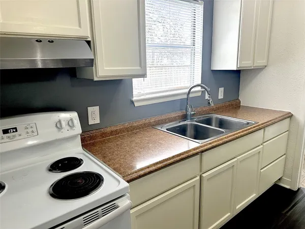 a kitchen with a sink and cabinets