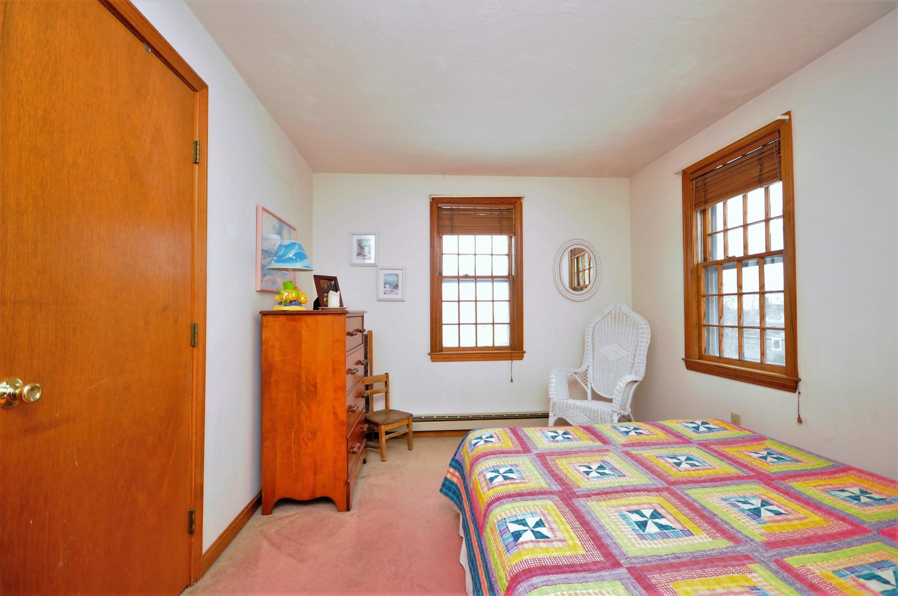 15 McGrath Road Sagamore Beach, MA 02562 - Photo 12 of 24 a bedroom with a bed and a window