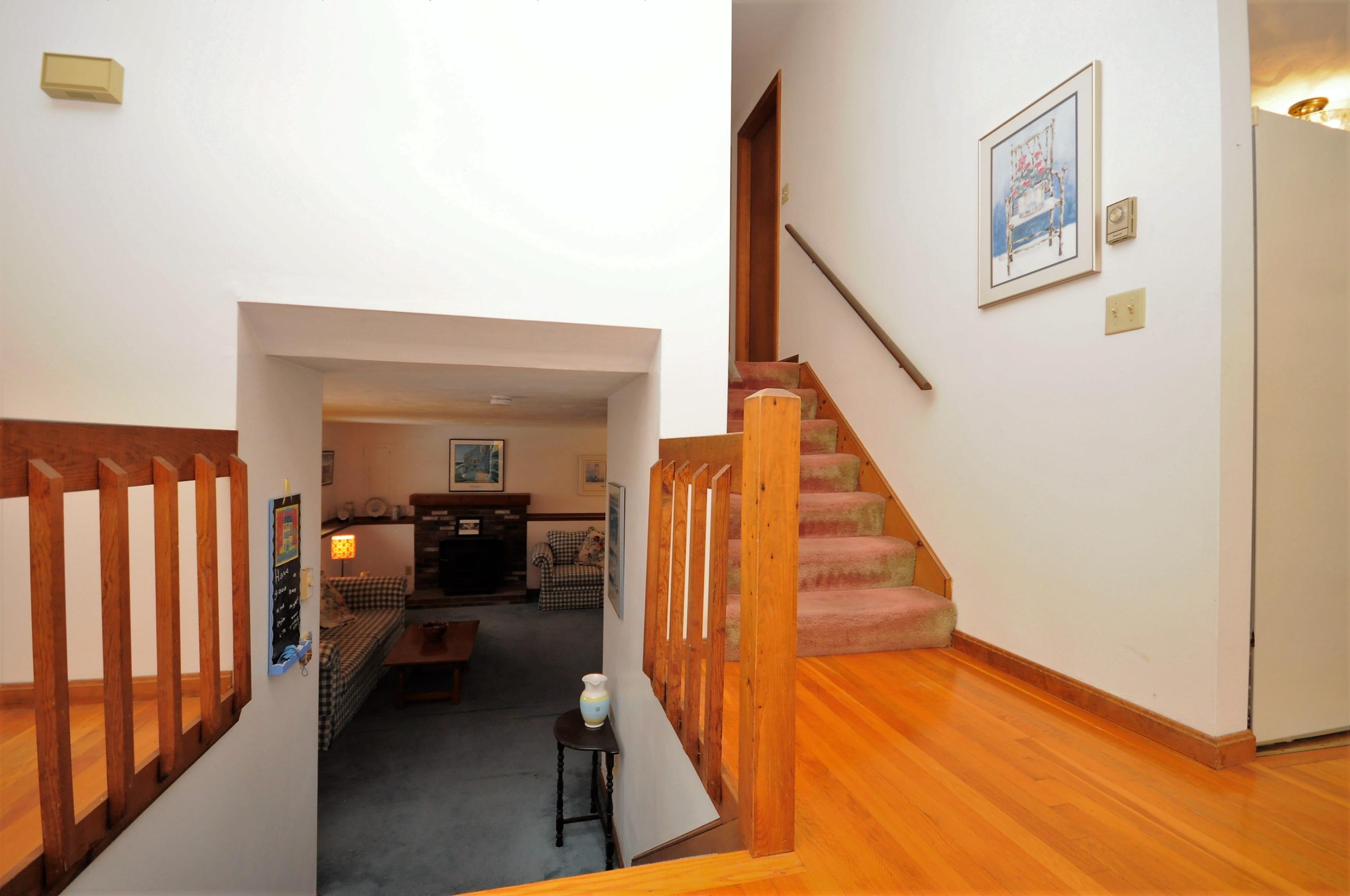 15 McGrath Road Sagamore Beach, MA 02562 - Photo 15 of 24 a view of a hallway with furniture and stairs