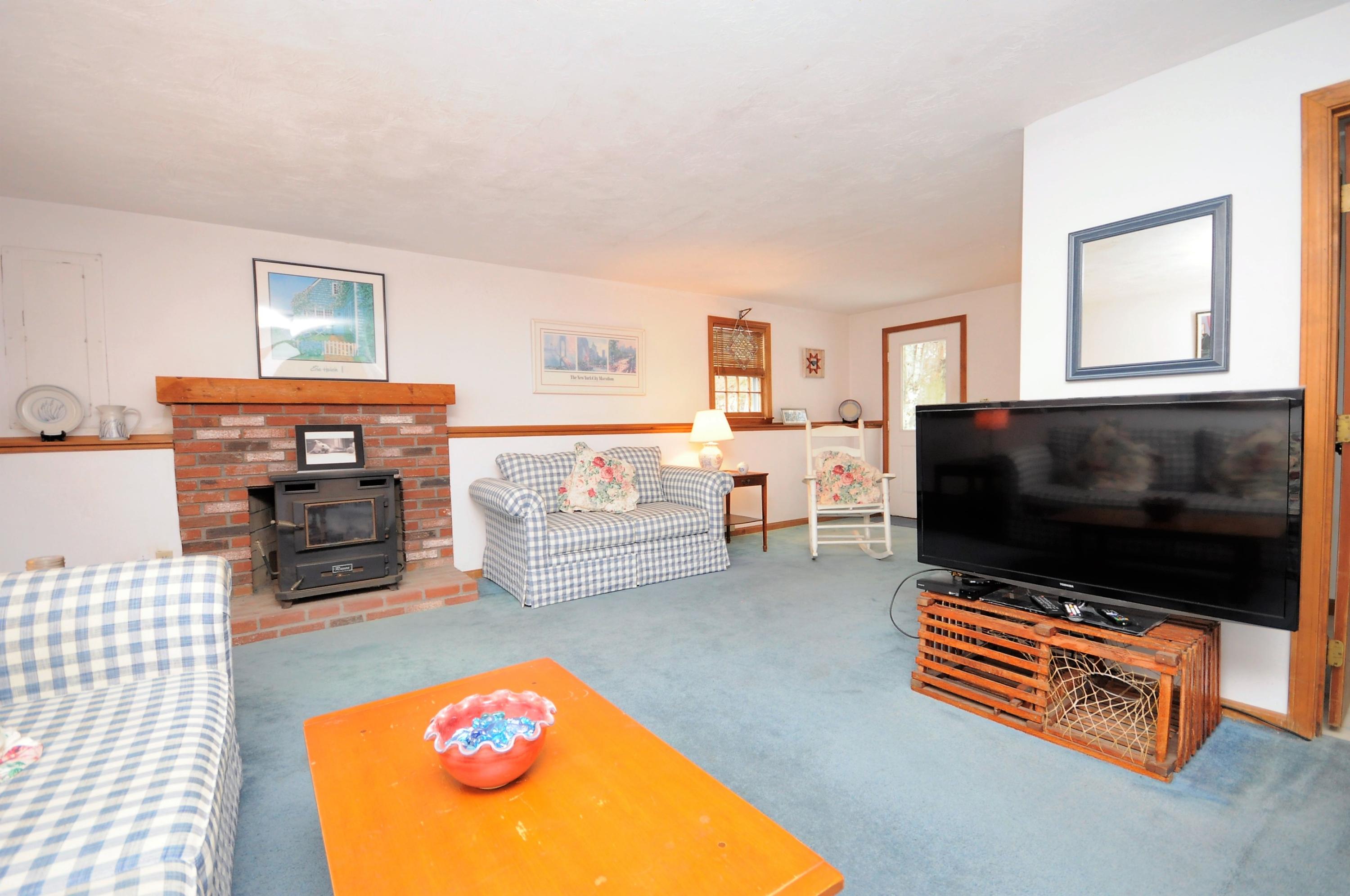 15 McGrath Road Sagamore Beach, MA 02562 - Photo 16 of 24 a living room with furniture and a flat screen tv