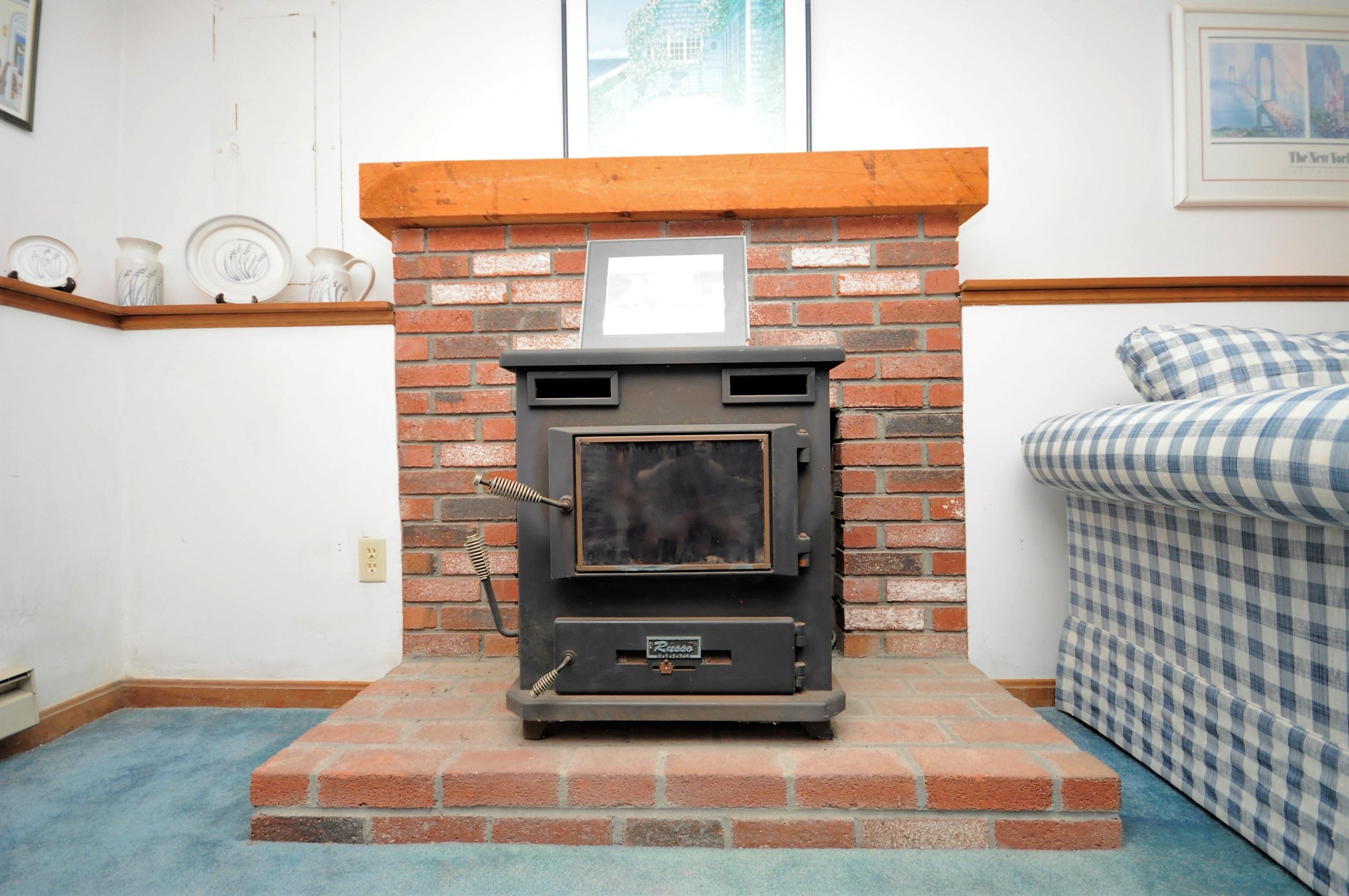 15 McGrath Road Sagamore Beach, MA 02562 - Photo 18 of 24 a living room with a couch and a stove