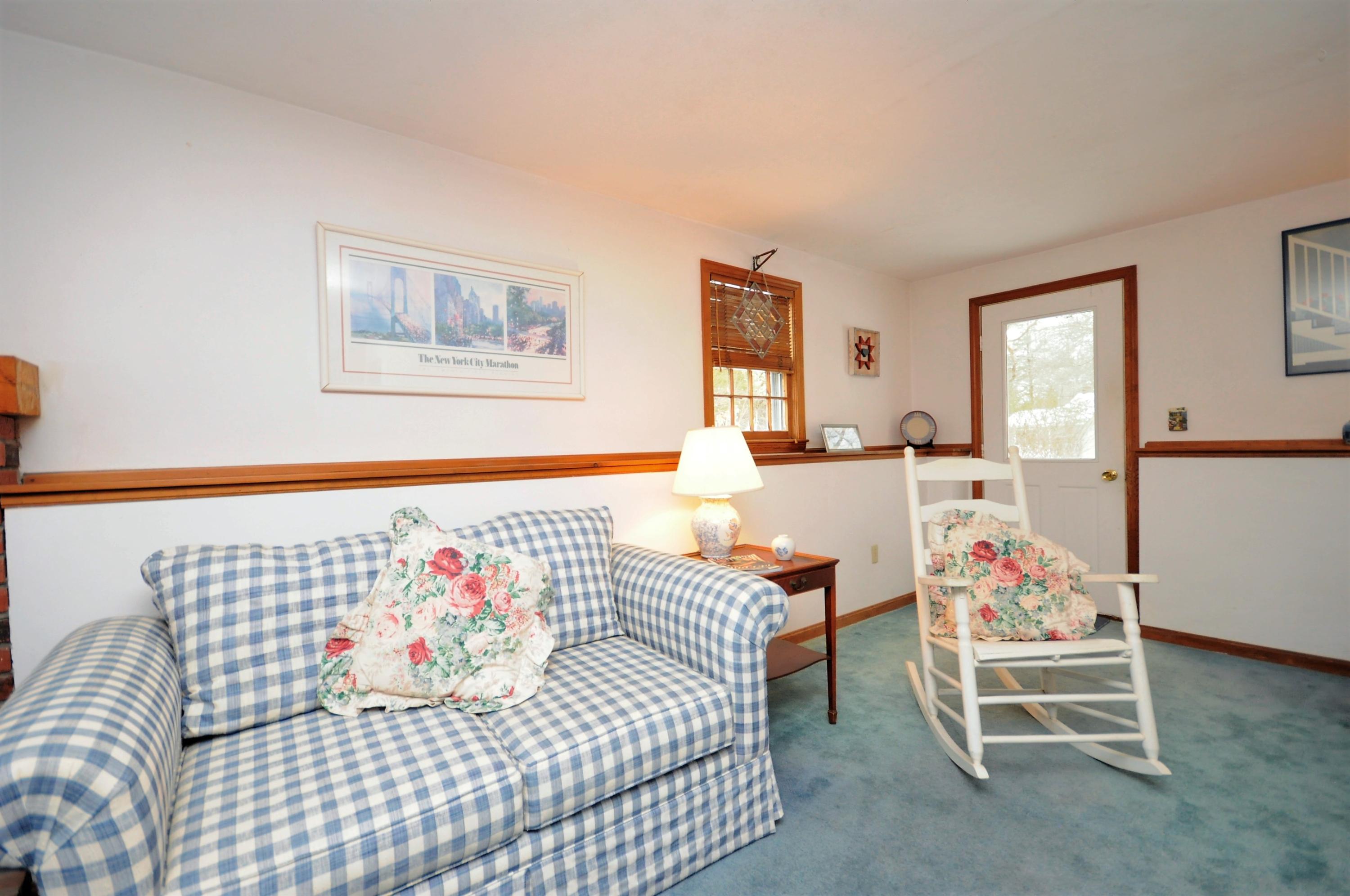 15 McGrath Road Sagamore Beach, MA 02562 - Photo 20 of 24 a living room with furniture and a table