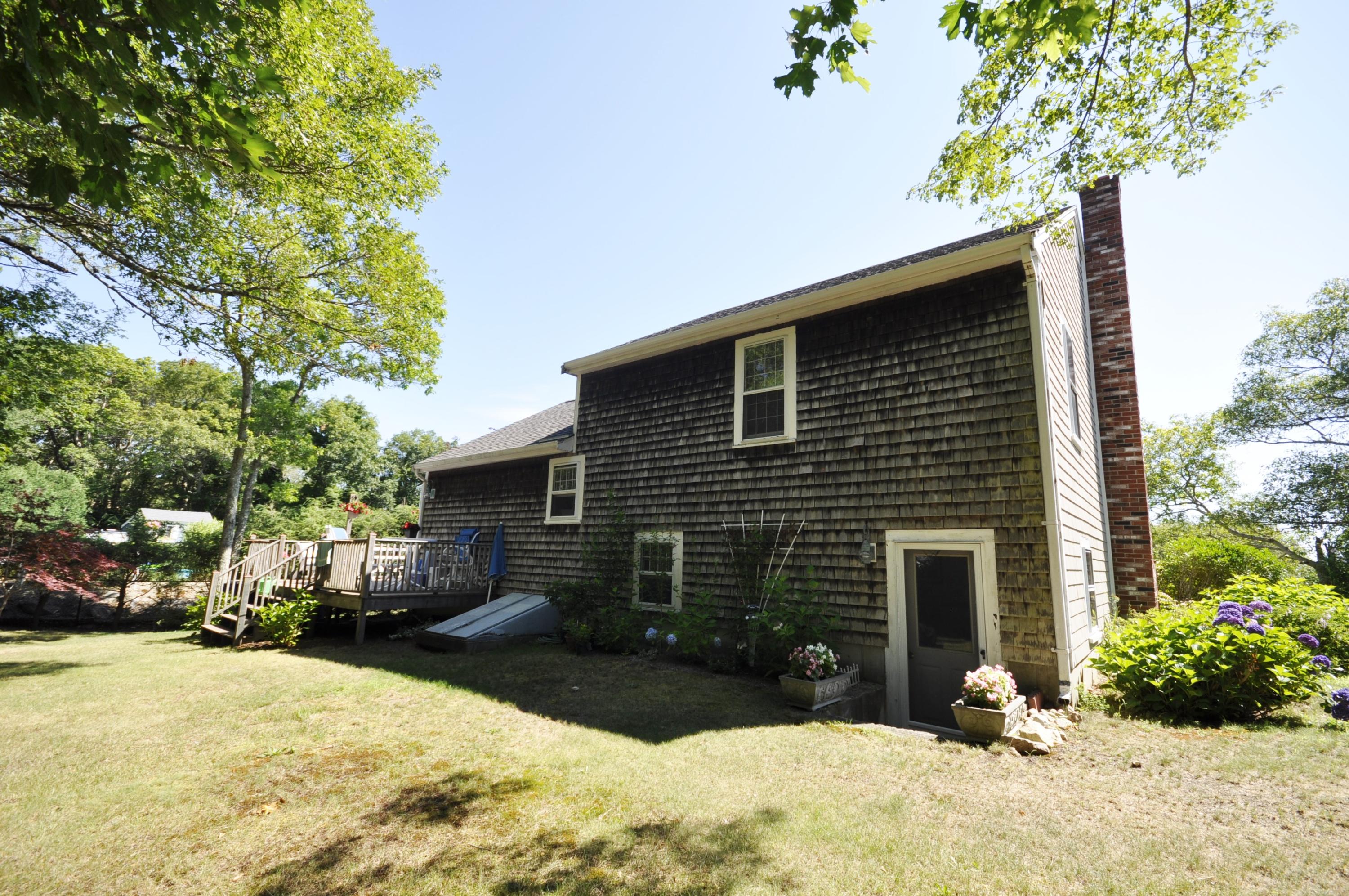 15 McGrath Road Sagamore Beach, MA 02562 - Photo 21 of 24 a front view of a house with a yard