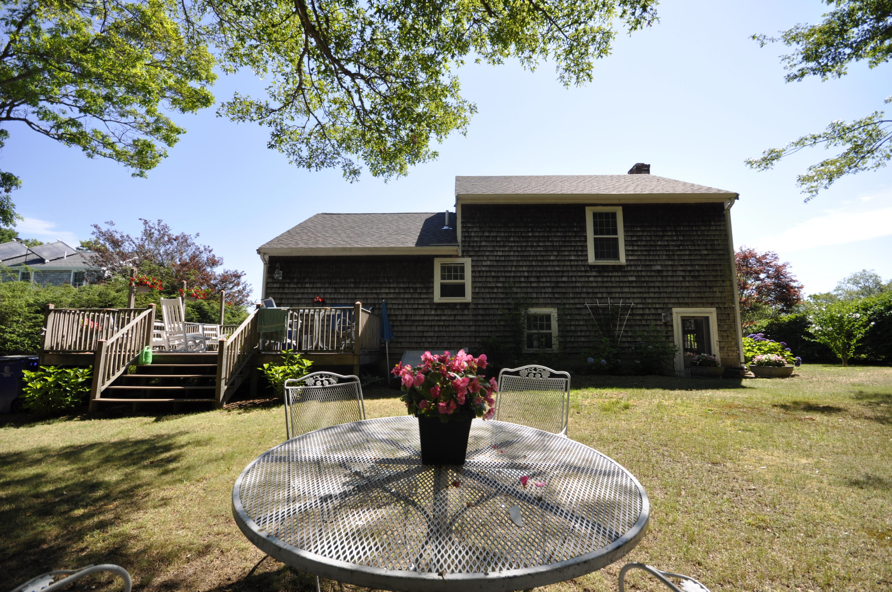 15 McGrath Road Sagamore Beach, MA 02562 - Photo 23 of 24 a front view of a house with yard seating area and barbeque oven