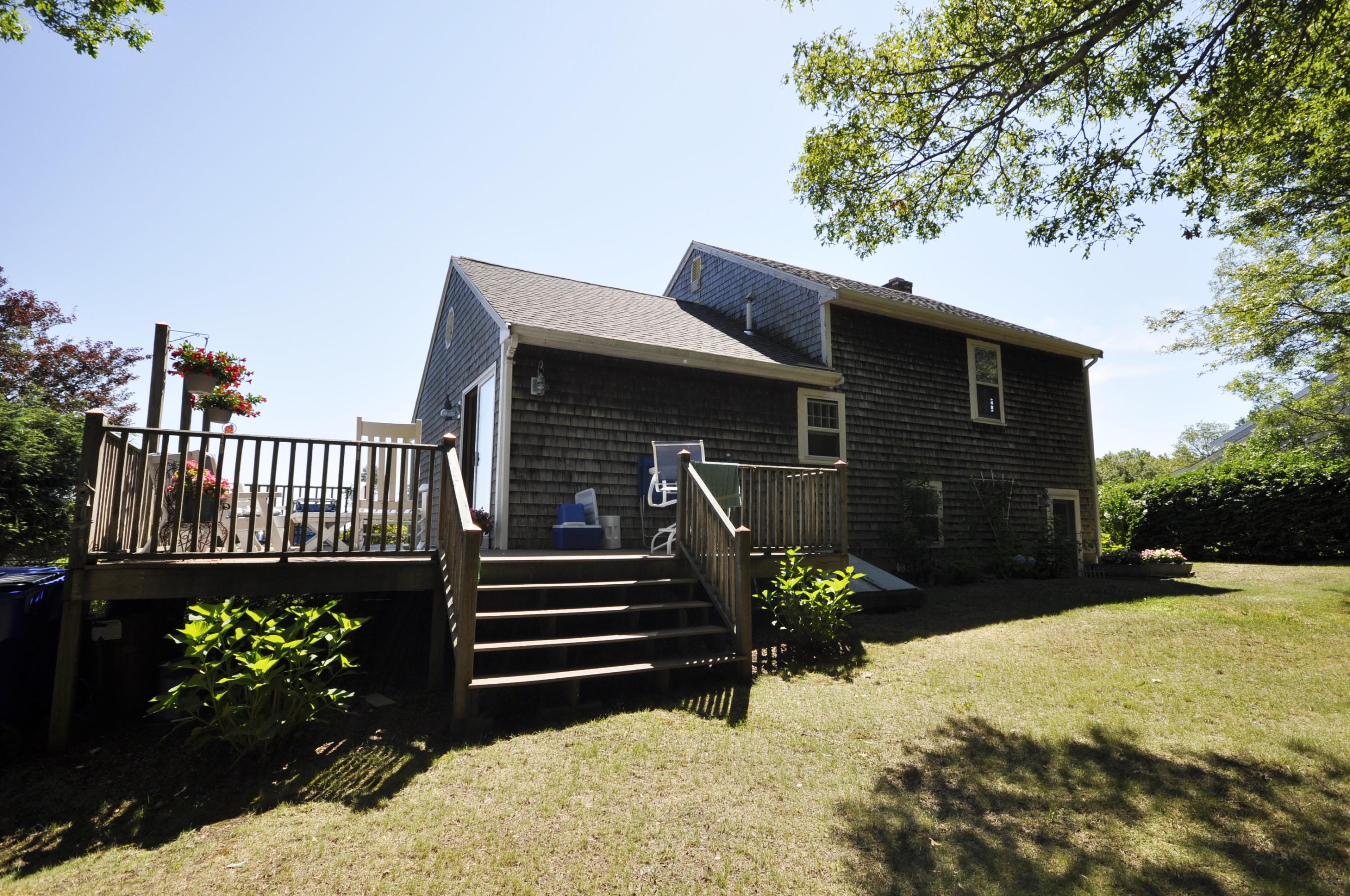 15 McGrath Road Sagamore Beach, MA 02562 - Photo 24 of 24 a view of a house with a yard and a garden