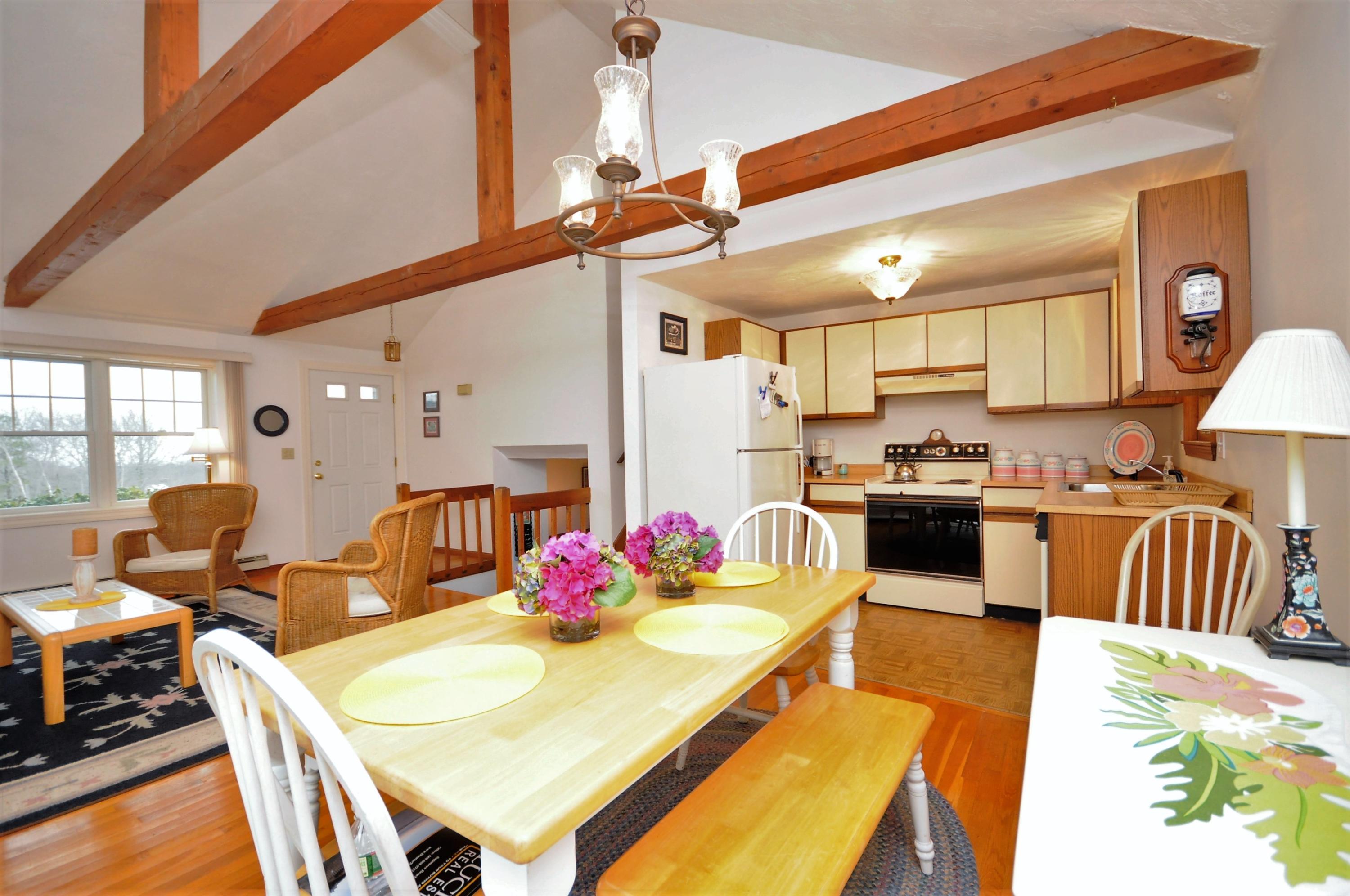 15 McGrath Road Sagamore Beach, MA 02562 - Photo 7 of 24 a kitchen with stainless steel appliances kitchen island granite countertop a dining table chairs refrigerator and sink