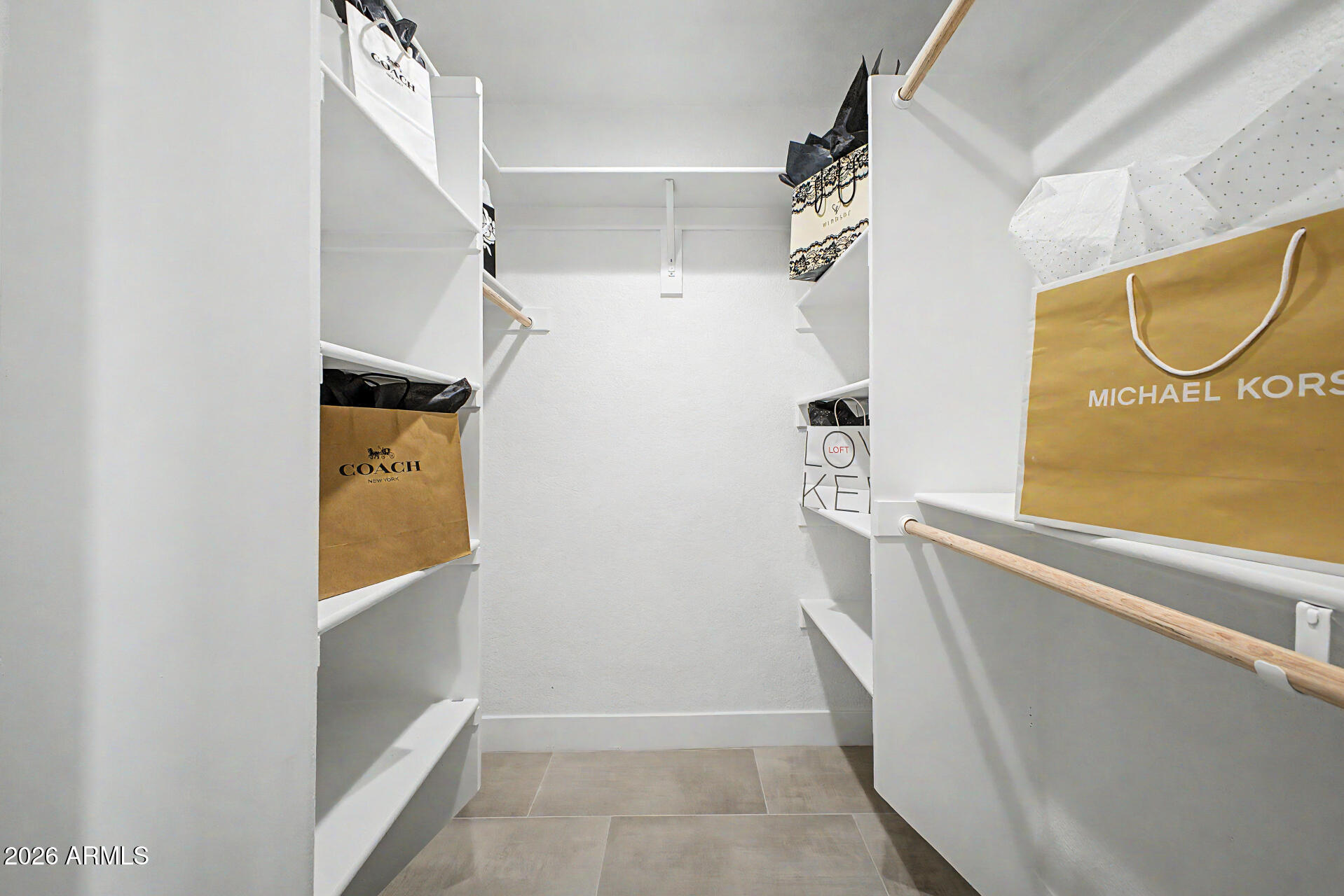 1009 West Pampa Avenue Mesa, AZ 85210 - Photo 19 of 31 a view of walk in closet with clothes and window