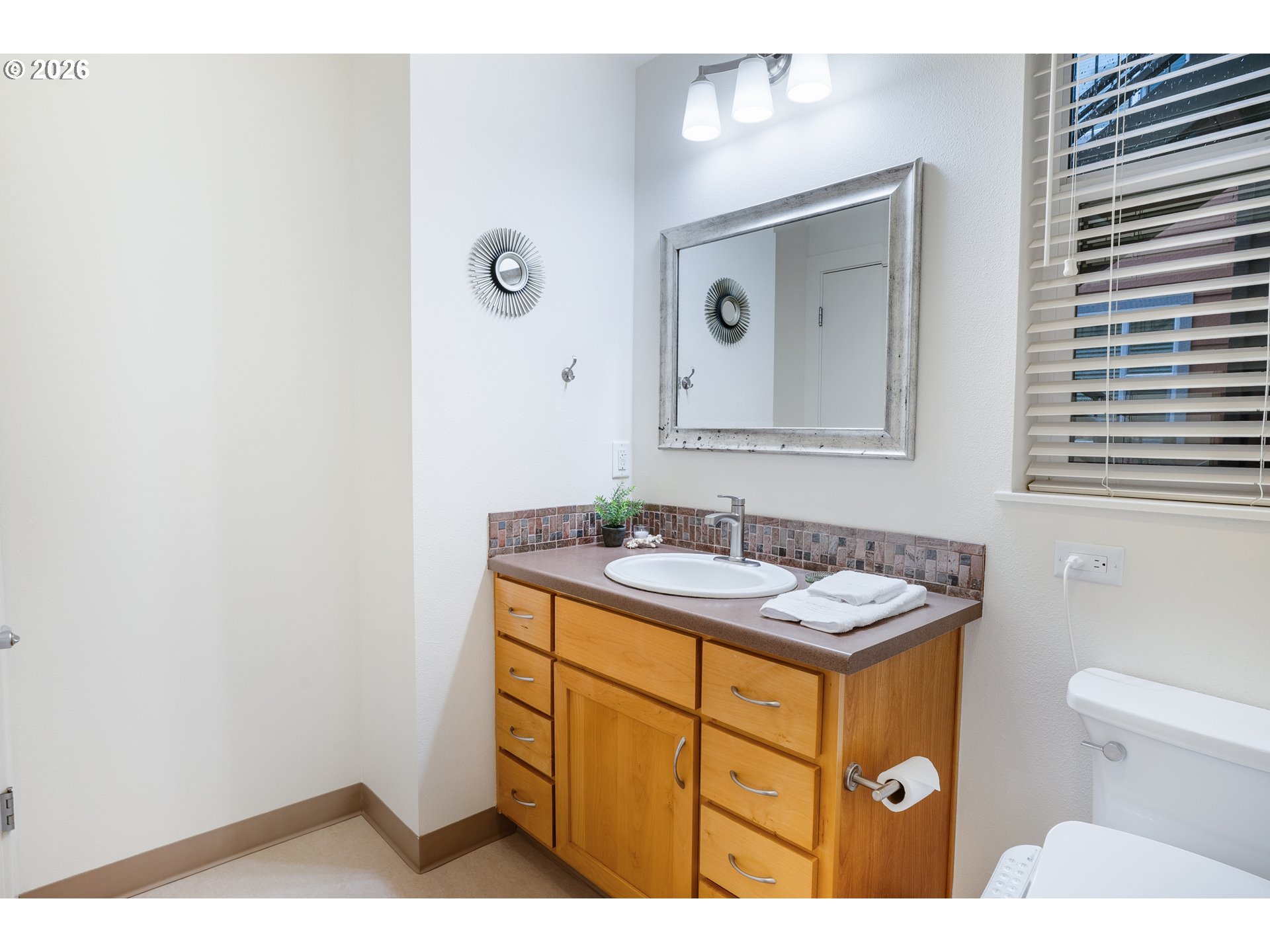 347 Rustic Place, Unit 14 Eugene, OR 97401 - Photo 11 of 20 a bathroom with a sink a toilet and mirror