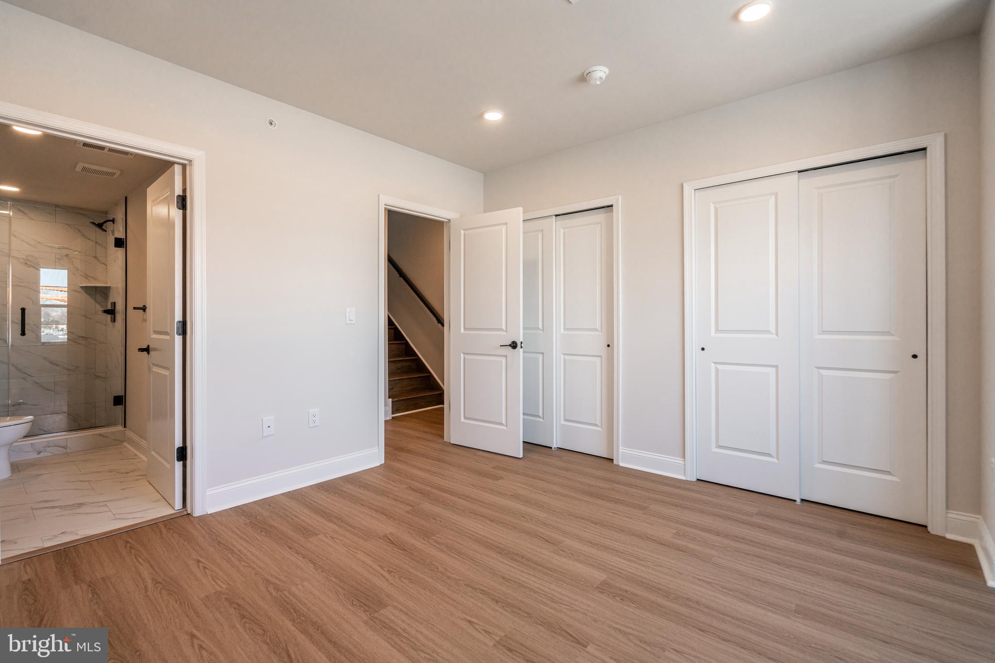 2701 Maya Lane, Unit A52 Philadelphia, PA 19131 - Photo 11 of 17 an empty room with wooden floor and entrance