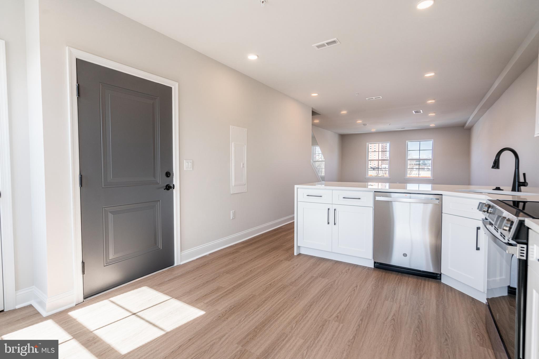 2701 Maya Lane, Unit A52 Philadelphia, PA 19131 - Photo 3 of 17 a kitchen with white cabinets and stainless steel appliances