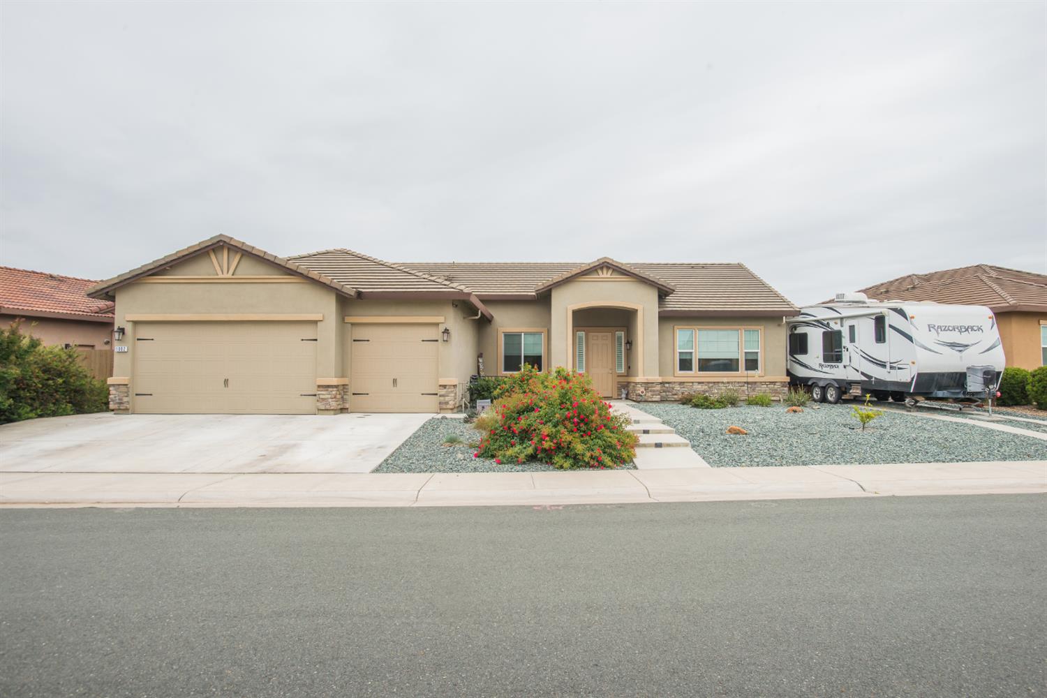 1082 Marichal Way Galt, CA 95632 - Photo 1 of 45 a front view of a house with a yard and garage