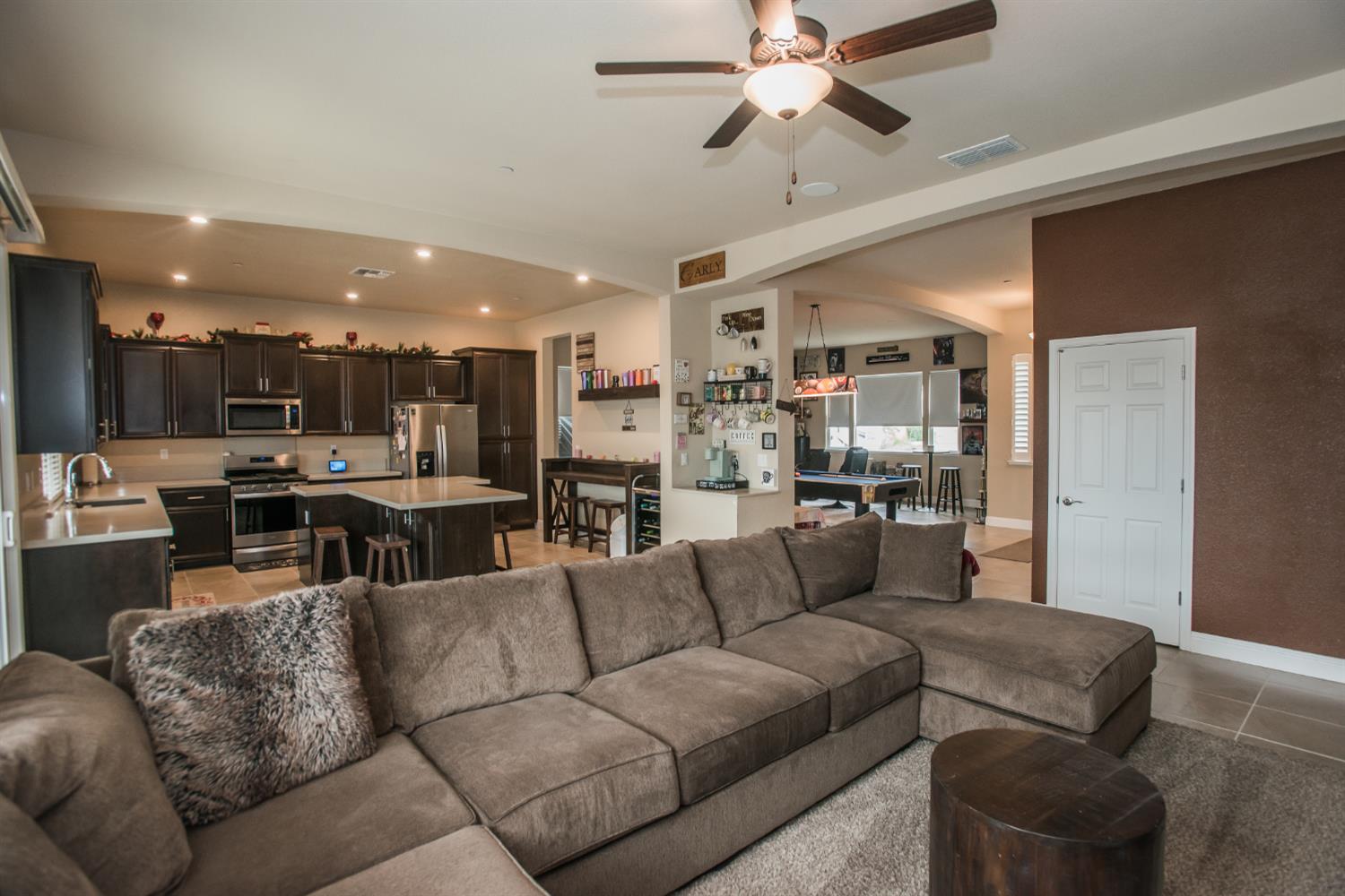1082 Marichal Way Galt, CA 95632 - Photo 12 of 45 a living room with furniture kitchen view and a chandelier