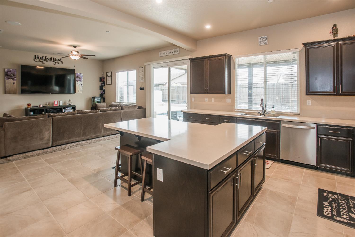 1082 Marichal Way Galt, CA 95632 - Photo 19 of 45 a large kitchen with kitchen island a sink table and chairs