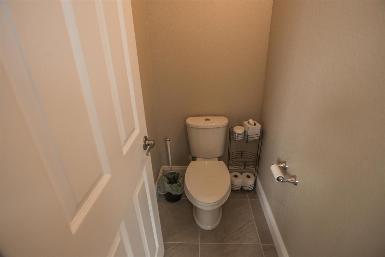1082 Marichal Way Galt, CA 95632 - Photo 28 of 45 a white toilet sitting in a bathroom