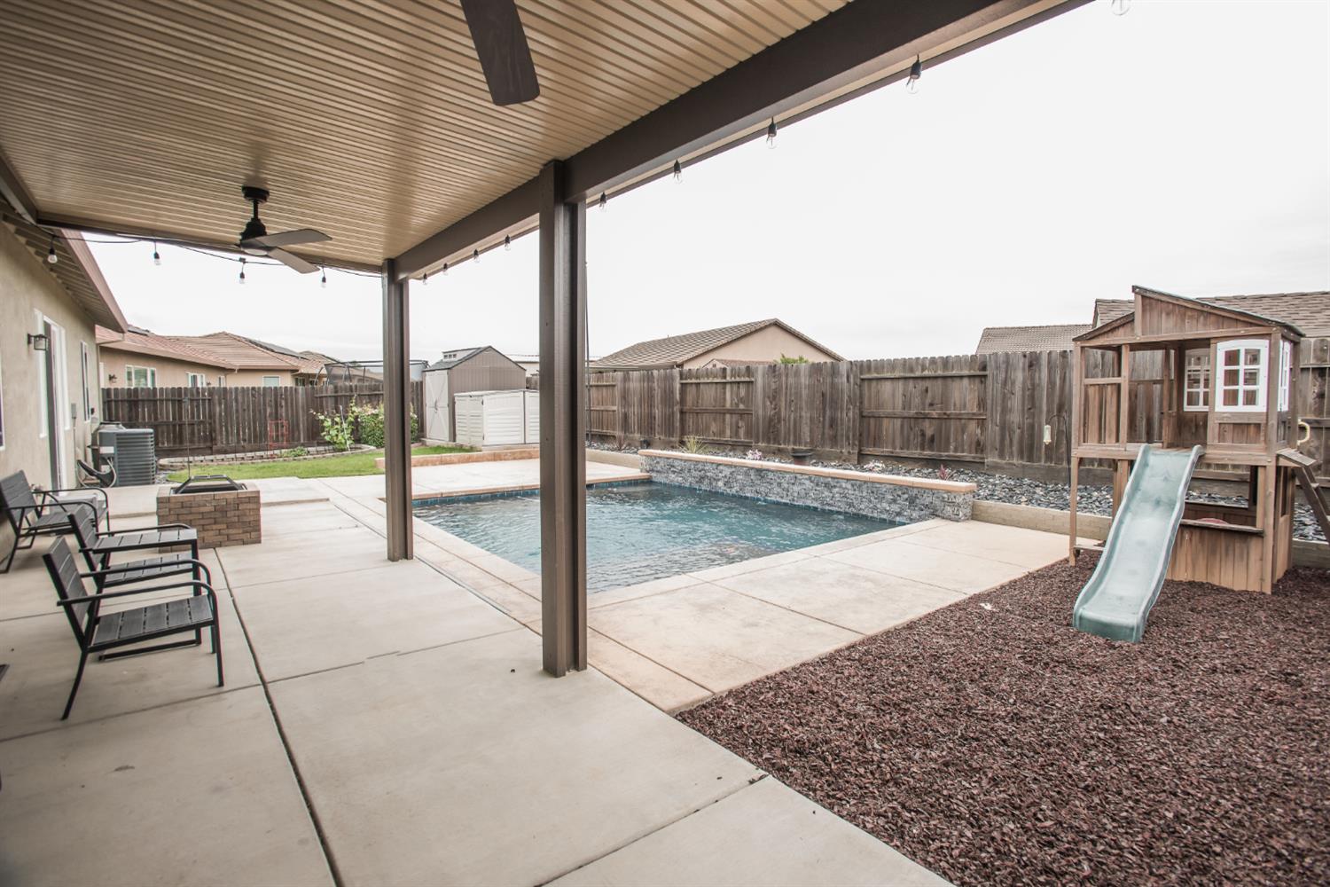 1082 Marichal Way Galt, CA 95632 - Photo 38 of 45 a view of a swimming pool with a lounge chairs