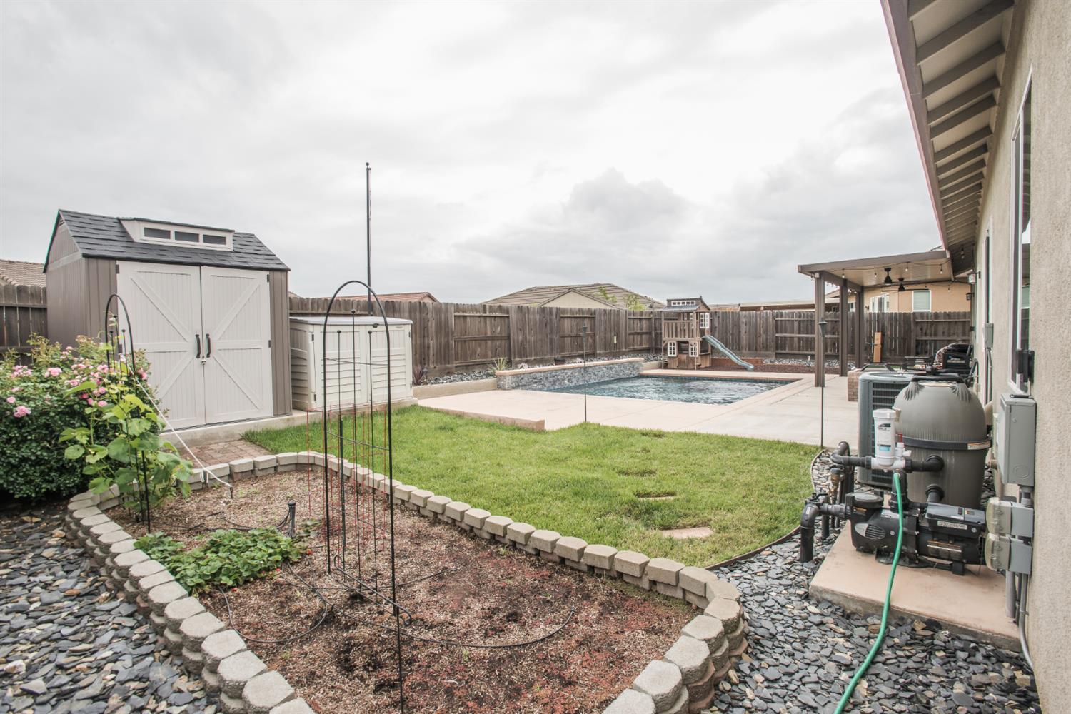 1082 Marichal Way Galt, CA 95632 - Photo 41 of 45 a view of a patio with a table chairs and a backyard