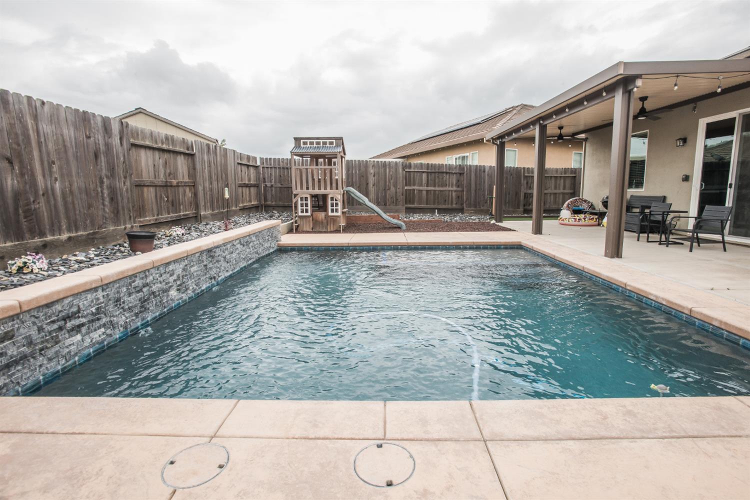 1082 Marichal Way Galt, CA 95632 - Photo 43 of 45 a view of a swimming pool with a chair
