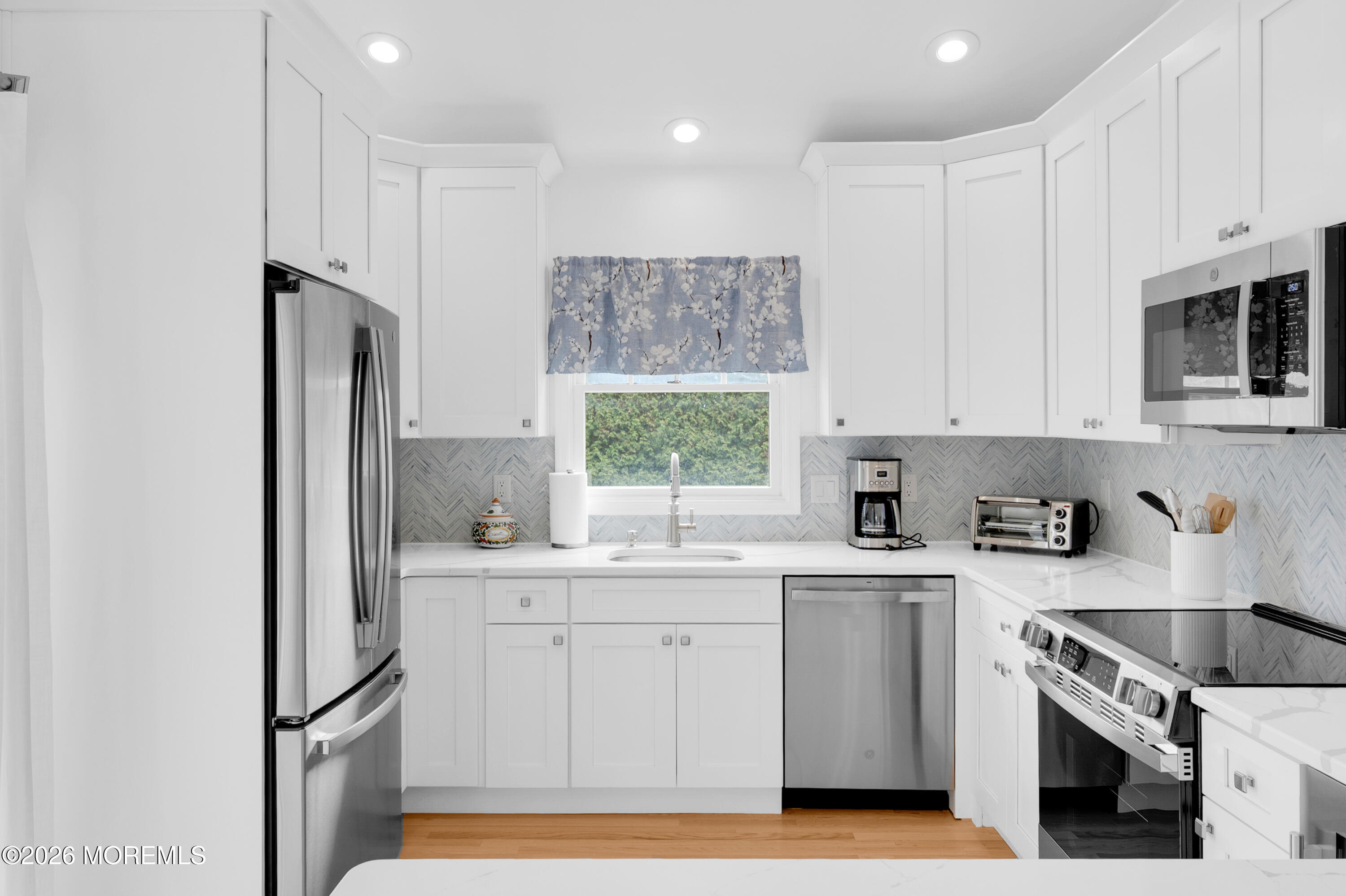 41 A Mount Street Bay Head, NJ 08742 - Photo 3 of 33 a kitchen with white cabinets stainless steel appliances and a window