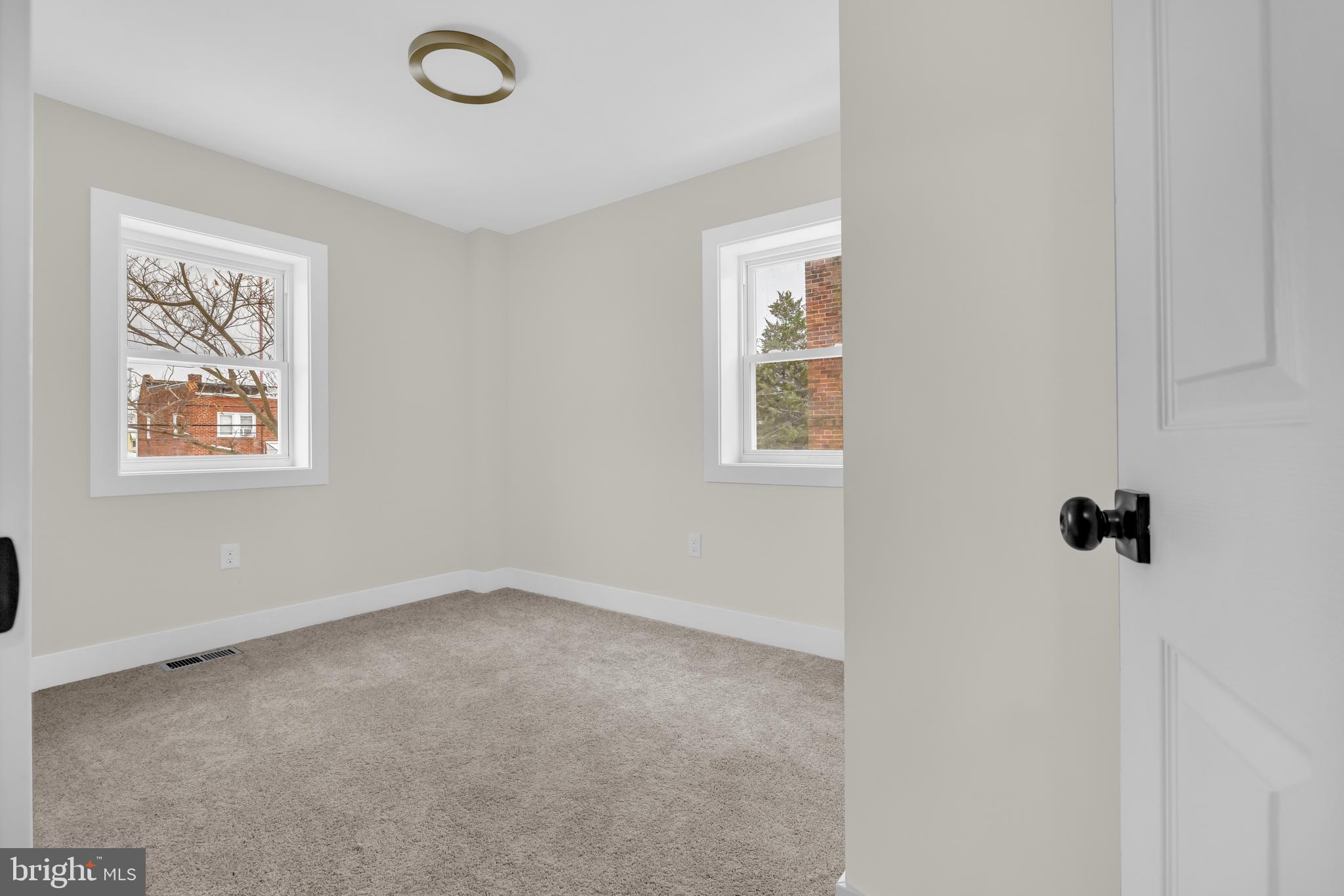 3827 Cottage Avenue Baltimore, MD 21215 - Photo 16 of 43 an empty room with windows