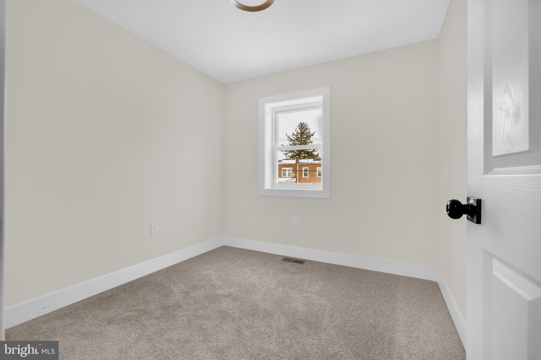 3827 Cottage Avenue Baltimore, MD 21215 - Photo 18 of 43 an empty room with windows