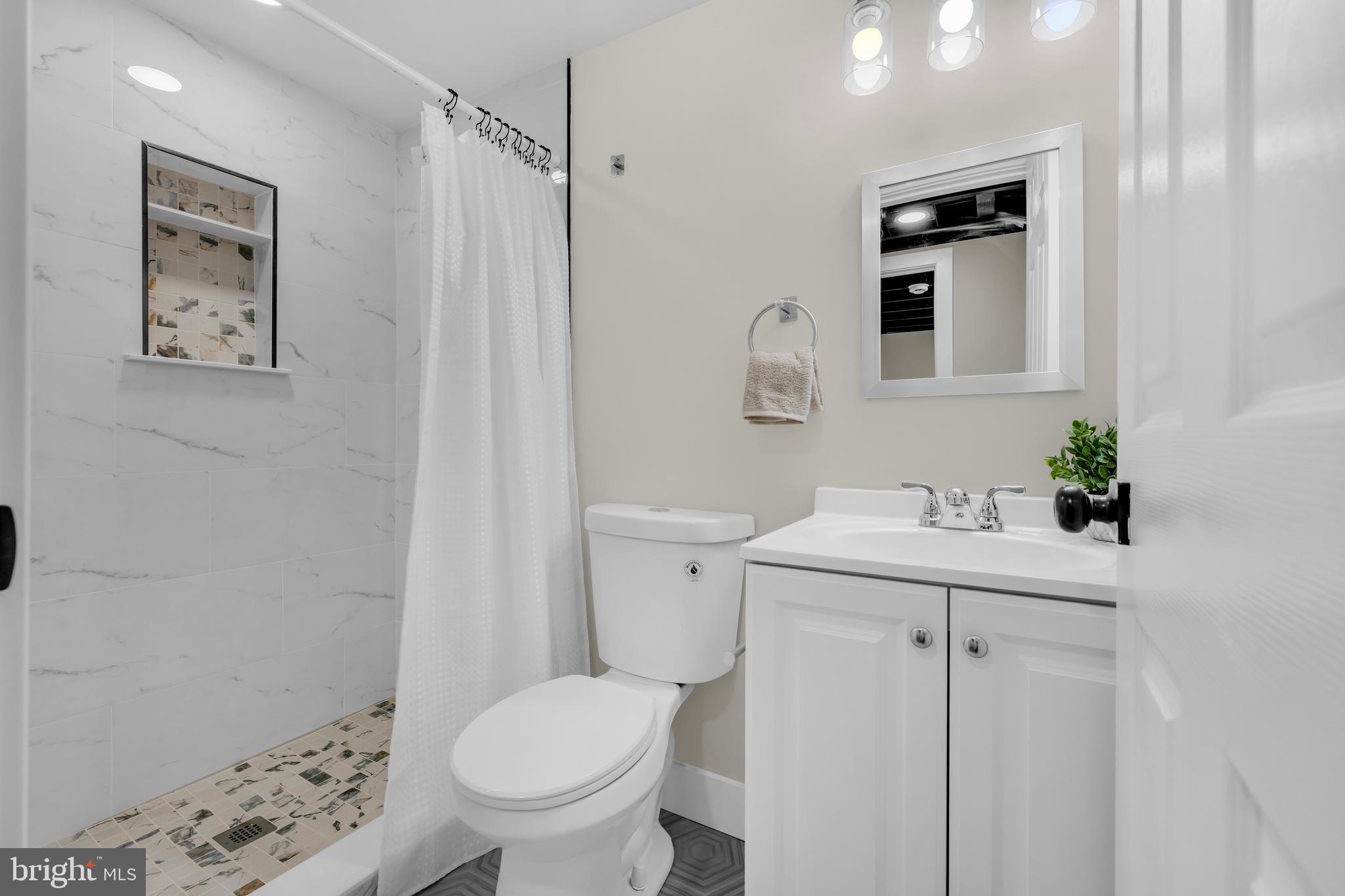3827 Cottage Avenue Baltimore, MD 21215 - Photo 20 of 43 a bathroom with a sink a toilet and shower